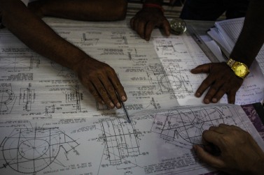 Employees dicussing over a project drawing